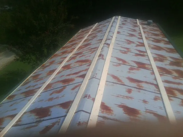 Rusted metal roof panels with new wood purlins before replacement — Storm Damage Roof Repair in Kiamesha Lake by Roofing Brothers